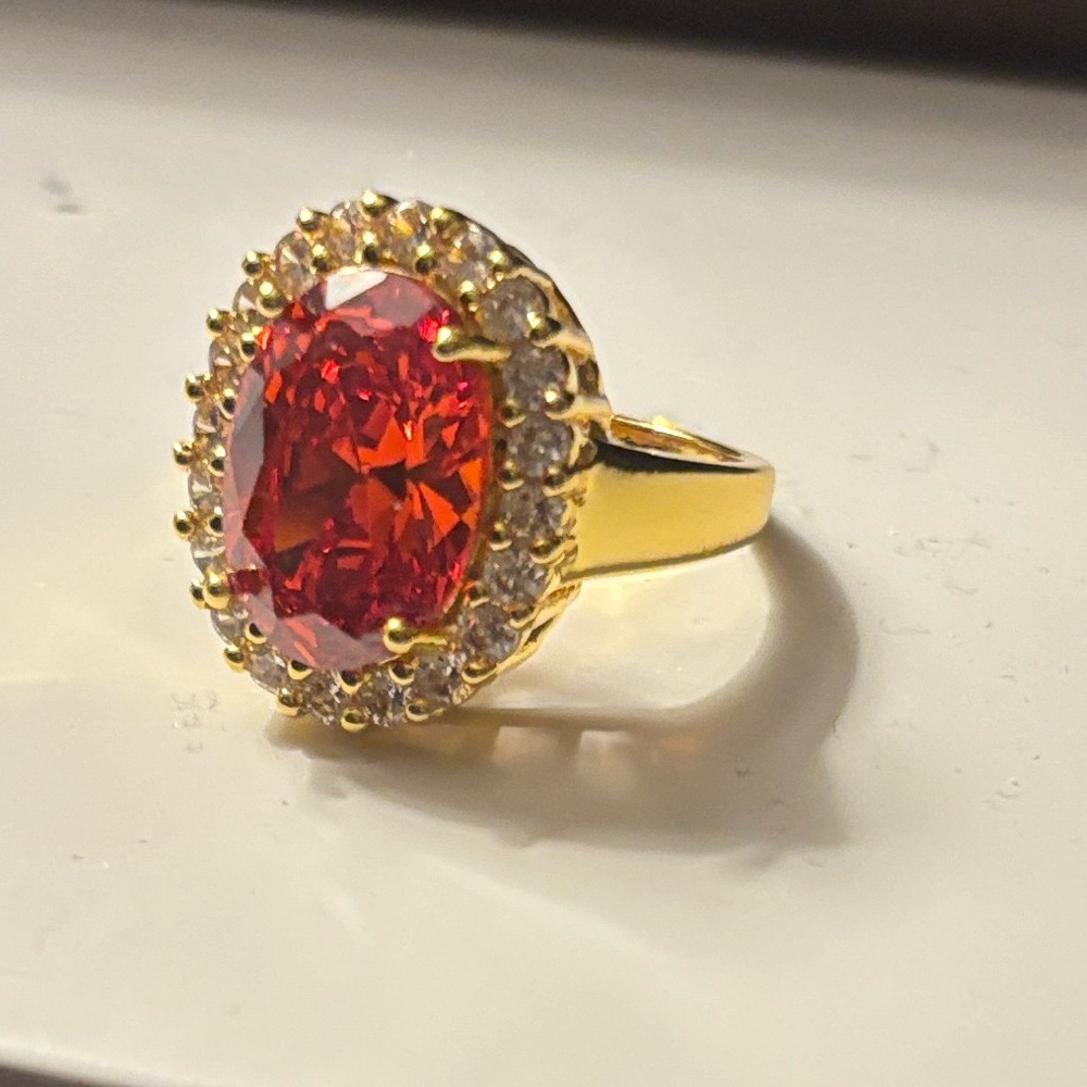 Gold Ring with Red Oval Gem and Halo Accent